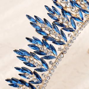 Detailed close-up of bridal crown showing blue marquise rhinestones on gold frame