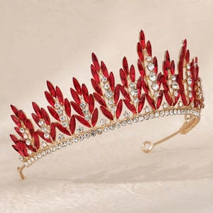 Detailed close-up of golden crown with red marquise crystals and shimmering rhinestones