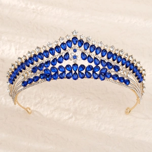Vue macro des strass bleus sertis sur une couronne dorée sur fond en peluche