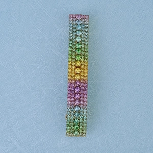 Detail of colorful rainbow rhinestone hair clip with shimmering crystal stones on metal base