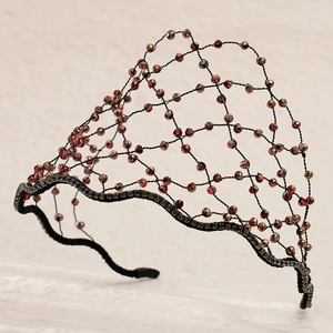 Close-up of hand-woven mesh headband with faceted crystal beads and rhinestone details