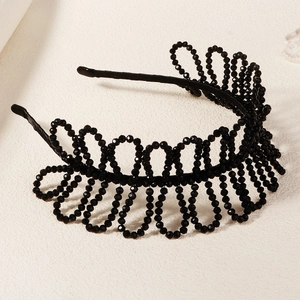 Detail of handcrafted black crystal bead crown headband with elegant hollow weave design