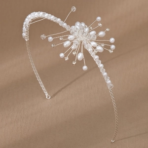Detailed view of silver wire floral headband with white pearls and clear crystals