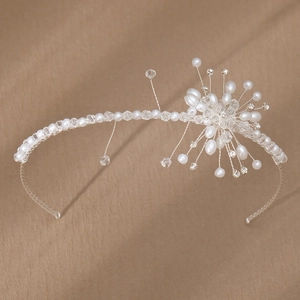 Detail of handmade bridal headband with white pearls and sparkling crystal flowers