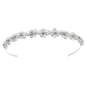 Close-up of bridal headband with intricate white pearls and faceted crystals on silver wire