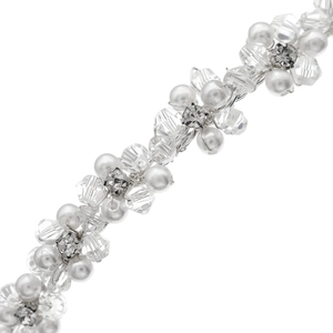 Macro shot of bridal headpiece featuring hand-wired crystals, pearls, and metal flowers