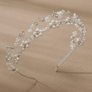 Detail of handmade bridal headband with white pearls and crystals on silver wire