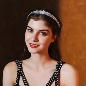 Detailed close-up of leaf-patterned silver headband with sparkling cubic zirconia crystals
