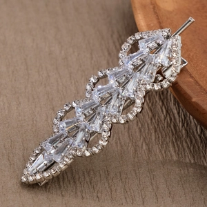 Macro detail of silver leaf hair clip with sparkling cubic zirconia stones and metal clasp