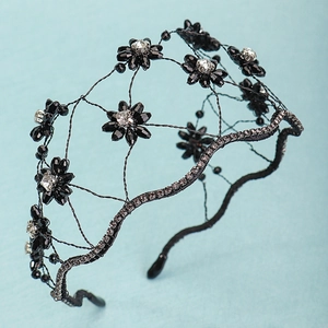 Macro detail of black crystal flower headband with rhinestones and mesh wire texture