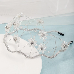 Detail of handmade silver bridal headband with crystal flowers and woven wire mesh structure