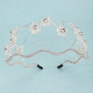 Macro shot of silver bridal headband with handmade crystal flowers and rhinestones