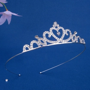 Close-up of heart-shaped silver crown headband with sparkling rhinestones details