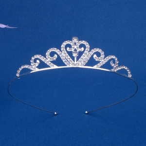Detailed view of silver-plated tiara headband with heart patterns and rhinestones