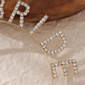 Detailed macro view of sparkling crystal rhinestones set in a golden bridal headband