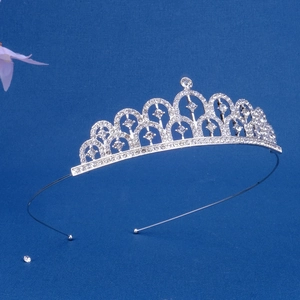 Close-up of silver rhinestone crown headband with arched geometric patterns for girls