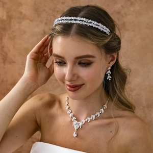 Close-up of bridal crystal jewelry set with leaf patterns and shimmering zircons