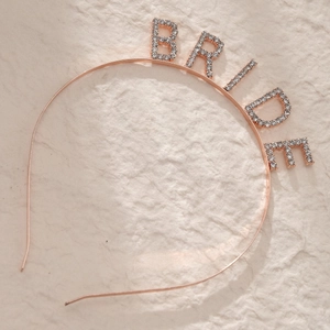 Close-up of rose gold BRIDE headband with sparkling rhinestones for wedding parties