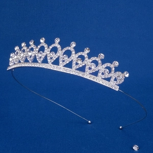 Close-up of a silver tiara crown for girls featuring heart patterns and shiny rhinestones