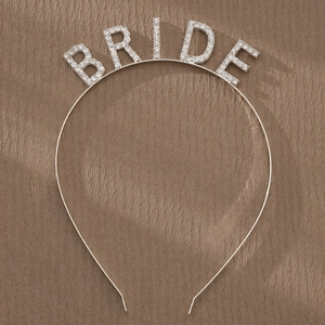 Detail showing silver bridal headband with sparkling rhinestone 'BRIDE' lettering
