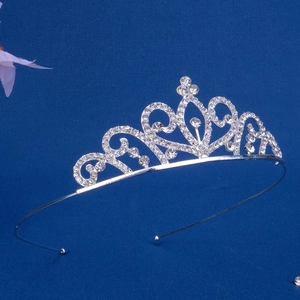 Macro detail of silver alloy tiara with sparkling crystal scrolls and waterdrop rhinestones