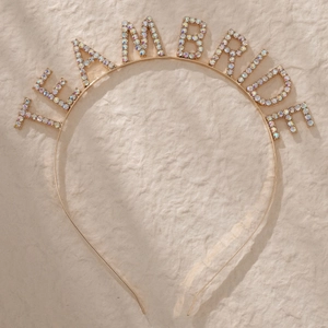 Detail of golden metal headband with Team Bride lettering encrusted with rhinestones