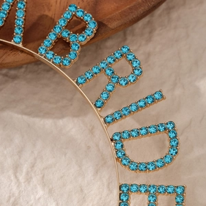Golden bridal headband with blue rhinestones spelling BRIDE for wedding party and event