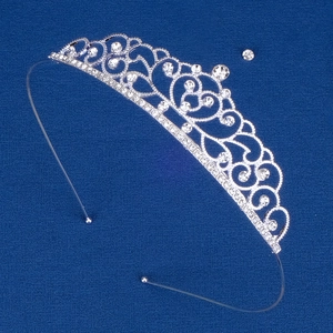 Detail of silver alloy crown headband with clear rhinestones and heart scroll patterns