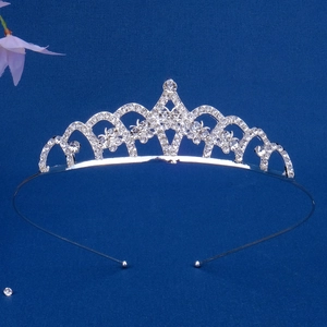 Detailed top view of silver rhinestone tiara headband with elegant wavy crystal patterns