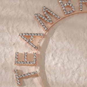 Close-up of sparkling rhinestones on rose gold Team Bride headband for bridal parties
