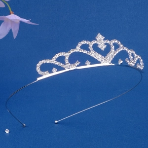 Close-up of heart-patterned silver tiara with rhinestones for girls' dance parties