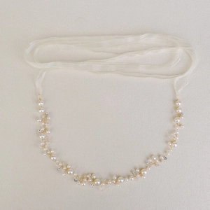 Detail of handcrafted bridal belt with white pearls, crystals and ivory ribbon