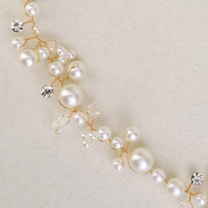 Close-up of handmade gold floral waist chain with white pearls and crystal rhinestones
