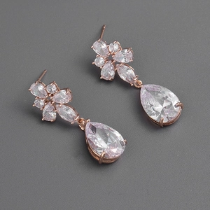 Detail of rose gold flower drop earrings with clear marquise and pear cut cubic zirconia
