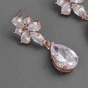 Macro shot of rose gold water drop earrings with pink zircon flower clusters