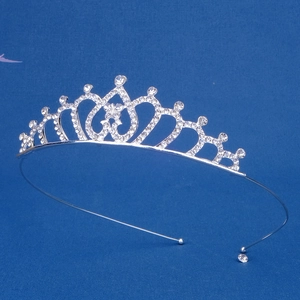 Macro detail of silver alloy tiara featuring heart patterns and white rhinestones