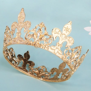 Detailed view of luxury gold crown featuring fleur-de-lis carving and sparkling rhinestones