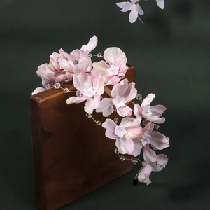 Vue détaillée de pétales de soie et perles de cristal sur un serre-tête floral élégant