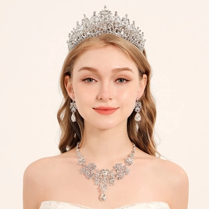Detailed view of elegant bridal jewelry set including crystal crown and teardrop earrings