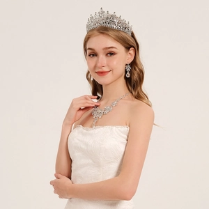 Exquisite bridal jewelry set with sparkling crown, necklace and teardrop earrings on model