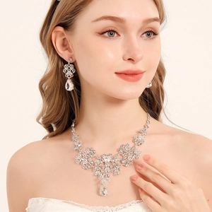 Close-up of luxury bridal jewelry set with sparkling rhinestones and teardrop pendants