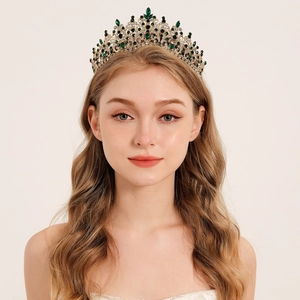 Detail of vintage gold bridal tiara with deep green emerald stones and sparkling crystals