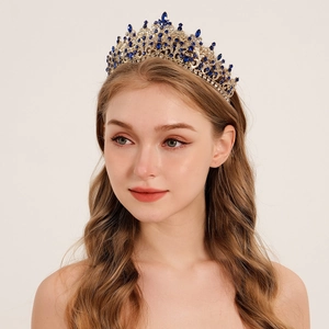Elegant gold bridal tiara with deep blue gemstones and sparkling crystals in a royal style
