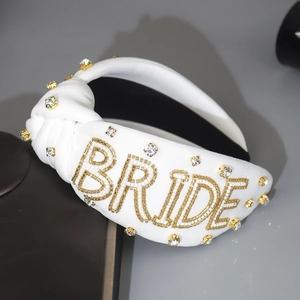 White knotted bridal headband with pearl BRIDE lettering and sparkling rhinestones