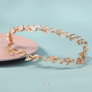 Romantic bridal headband with gold leaves, white flowers and crystals on blue background