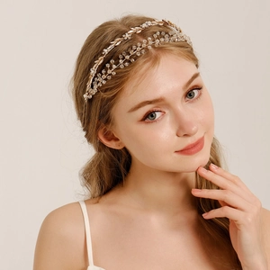 Detail view of double-layer floral headband with gold leaves, pearls, and crystals