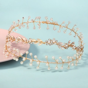 Detailed shot of handmade bridal headband with gold leaves, pearls and crystal beads