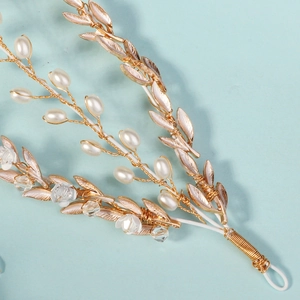 Détail macro du bandeau floral fait main avec fil d'or, perles et fleurs de cristal