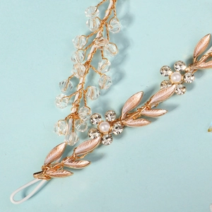 Detail of bridal headband with crystal beads pearls and gold leaf floral accents