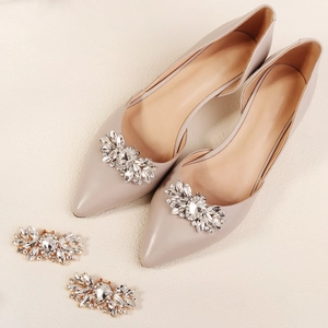 Detail of elegant pointed toe pump featuring a removable oversized sparkling crystal shoe clip
